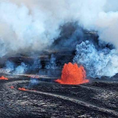 Lava spewing from a volcanic fissure, surrounded by smoke and ash.